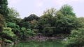 Pan video of Tokyo Metropolitan Park KyuFurukawa`s japanese garden`s Yukimi stone lantern overlooking Shinji pond in summer