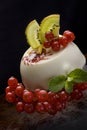 Panacota dessert decorated with orange, kiwi and berries Royalty Free Stock Photo