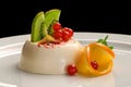 Panacota dessert decorated with orange, kiwi and berries