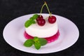 Panacotta dessert with cherry jelly on a black background. Royalty Free Stock Photo