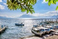 Boats, jetties & volcano, Lake Atitlan, Guatemala Royalty Free Stock Photo