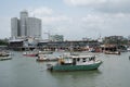 Fishing boats at commercial fish market harbour with skyline bac Royalty Free Stock Photo