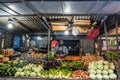 Market stand, man selling fruits and vegetable on food market in Royalty Free Stock Photo