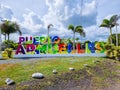 Panama, Port Armuelles, welcome sign with palm trees in the background