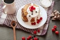 Pancackes with sour cream and tea on dark surface, top view of table decorated with muffins, raspberries, blueberries, spoon, Royalty Free Stock Photo