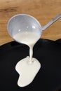 Pancake batter is poured into the pan