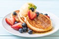 pancake with blueberries, strawberries, honey and vanilla ice-cream