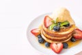 Pancake with blueberries, strawberries, honey and vanilla ice-cream