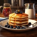 pancake with fresh blueberry and honey syrup on the white plate.