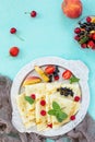 Pancake breakfast. Pancakes on a plate with honey and fresh berries of currants, strawberries, nectarines, sweet cherries and Royalty Free Stock Photo