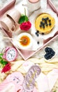 Pancake breakfast tray in bed with syrup and blueberries fruit flat lay. Royalty Free Stock Photo