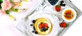 Pancake breakfast tray on table with syrup and blueberries fruit banner. Royalty Free Stock Photo