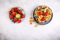 Pancake cereal. Heap of mini pancakes in gray bowl served with berries on concrete background. Trendy food. Top view