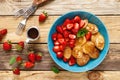 Pancake cereal, mini pancakes with fresh strawberry in a bowl with maple syrup Royalty Free Stock Photo