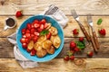 Pancake cereal, mini pancakes with fresh strawberry in a bowl with maple syrup Royalty Free Stock Photo