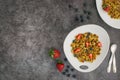 Pancake cereal. Trendy food, mini cereal pancakes in bowl on the table, grey cement background. Trendy baked mini