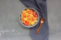 Pancake flakes with sliced strawberries on a gray background with a wooden spoon and a napkin. Tasty trending breakfast. Royalty Free Stock Photo