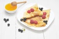 Pancake - Crepes with berries and honey Royalty Free Stock Photo