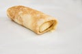 Pancake with curd rolled into a roll in a white plate. Close-up. Royalty Free Stock Photo