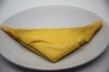 Pancake folded into a triangle on a white plate Royalty Free Stock Photo