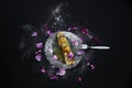 Pancake on glass plate decorated with sugar and petal. Royalty Free Stock Photo