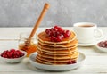 Pancake with honey and fresh berries. Cranberry, cowberry Royalty Free Stock Photo