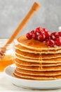 Pancake with honey and fresh berries. Cranberry, cowberry Royalty Free Stock Photo