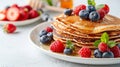 Pancake owl with berries and honey on white plate, kids breakfast concept, bright background Royalty Free Stock Photo