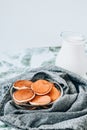 Pancake porridge, mini pancakes in a bowl with maple syrup. Milk on background. Dutch mini pancakes are called strawberry potato Royalty Free Stock Photo