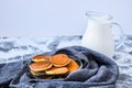 Pancake porridge, mini pancakes in a bowl with maple syrup. Milk on background. Dutch mini pancakes are called strawberry potato Royalty Free Stock Photo