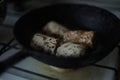Pancake rolls are fried in a pan. Russian traditional dish Royalty Free Stock Photo
