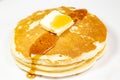 Pancake with a square of butter and syrup on a kitchen table waiting to be eaten Royalty Free Stock Photo