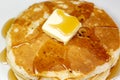 Pancake with a square of butter and syrup on a kitchen table waiting to be eaten Royalty Free Stock Photo