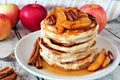 Pancake stack with apples, pecans and cinnamon and maple syrup Royalty Free Stock Photo