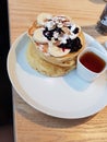 pancake stack with bananas, Blueberry jam and maple syrup