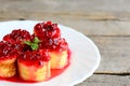 Pancake sushi rolls with red currant jam on a white plate and a vintage wooden table. Sweet pancakes dessert idea