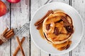 Pancakes with apples, pecans, cinnamon, maple syrup, overhead view Royalty Free Stock Photo