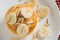 Pancakes with banana and almond slice on white dish. Top view. Royalty Free Stock Photo