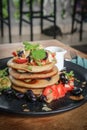 Pancakes with banana, blueberries, strawberries and chocolate sauce Royalty Free Stock Photo