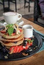 Pancakes with banana, blueberries, strawberries and chocolate sauce Royalty Free Stock Photo