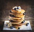 Pancakes with banana, blueberry and maple syrup for a breakfast Royalty Free Stock Photo