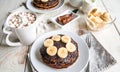 Pancakes with banana, with cacao on white wooden background. Healthy breakfast