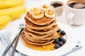 Pancakes with banana and golden maple syrup Royalty Free Stock Photo