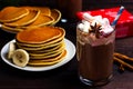 Pancakes with banana, maple syrup and a glass of hot chocolate with marshmallows and a drinking straw Royalty Free Stock Photo