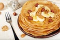 Pancakes with banana, nuts and honey. Dessert.