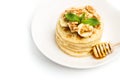 Pancakes with banana slices on a white plate Royalty Free Stock Photo