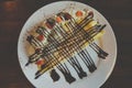 Pancakes with bananas and chocolate caramel sauce,Topping with whip cream and strawberry on table