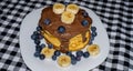 Pancakes with berries and banana slices chocolate cream Royalty Free Stock Photo