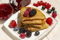 Pancakes with berries, Butter and tea in a white porcelain Cup. Healthy summer breakfast, homemade classic russian Royalty Free Stock Photo