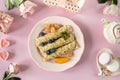 Pancakes with berries and honey on a pink pastel background, top view. Royalty Free Stock Photo